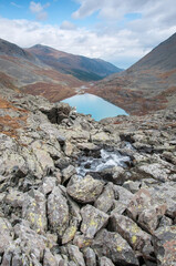 View on lake Akchan and part of Akchan valley with huge boulders in the foreground, the Altai Republic, Russia