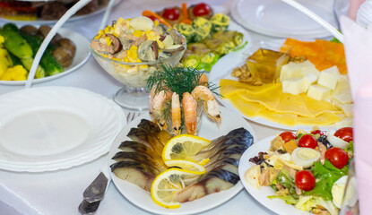 Seafood and salad spread at a festive buffet with fresh produce and colorful dishes