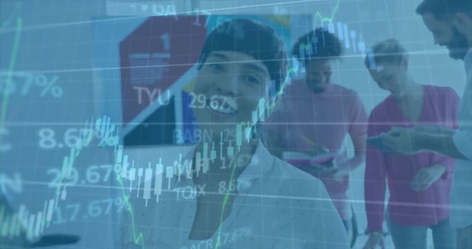 Presenter speaking while colleagues reviewing tablets as animated financial charts overlaying scene