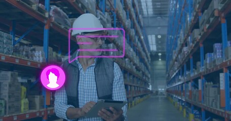 Warehouse manager tapping tablet as chat bubbles arrive, scanning shelves for stock updates - Powered by Adobe