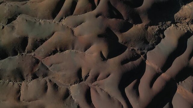 Aerial view of the undulating landscape of the Seven Colored Earth Geopark, displaying a mosaic of contrasting colors and textures, Chamarel, Rivi&egrave;re Noire District, Mauritius.