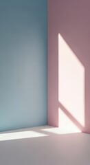 Sunlight from a window casts a geometric shadow in the corner of a room with pastel blue and pink walls.