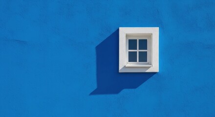 Single white window on a vibrant blue wall.