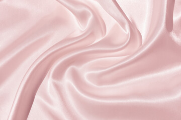 The texture of the satin fabric of pink color for the background