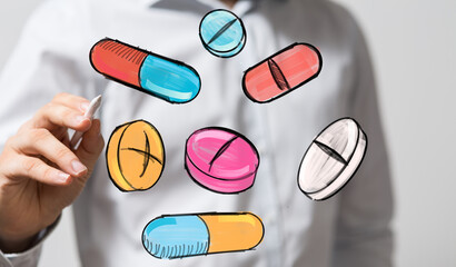 Image of hand drawing various pills and capsules. Healthcare, medicine, pharmacy concept.