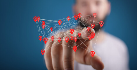 Man interacts with a digital map showing interconnected locations.  Global network, tracking, technology.