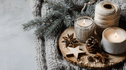 Cozy Winter Ambiance: A warmly lit scene, displaying candles, pine, stars, and twine, atop a wooden serving board with a soft, knitted texture in muted tones.