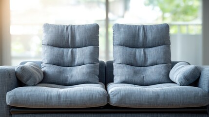 Cozy and Comfortable Grey Sofa with Soft Cushions in a Bright Modern Living Room Setting
