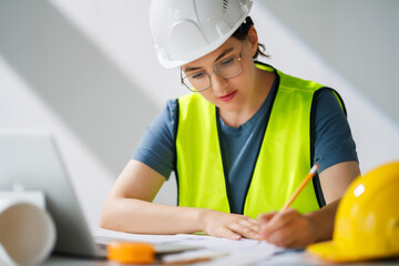 Woman architect is working on plans