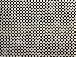 Close-up of perforated metal sheet with circular holes – industrial texture background ideal for architectural design, ventilation grilles, or mechanical pattern concepts.