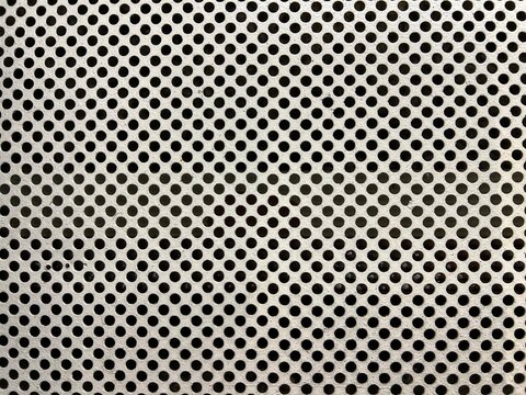 Close-up of perforated metal sheet with circular holes – industrial texture background ideal for architectural design, ventilation grilles, or mechanical pattern concepts.