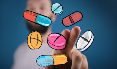 Image of a hand interacting with digital illustrations of various pills and capsules.  Perfect for healthcare, medicine, technology.