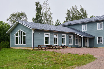 A Modern Blue Wooden House Nestled Within Beautiful Green Surroundings and Landscapes
