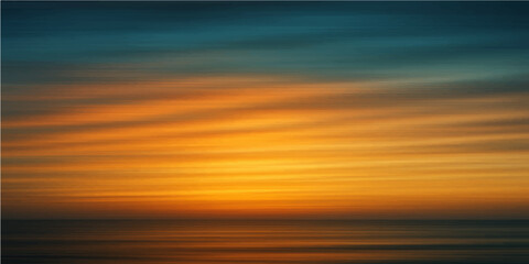 Obraz premium Evening orange sun sets on the horizon over the ocean waves with yellow clouds in the sky