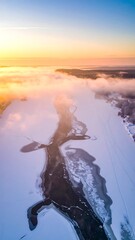 Aerial view of a frozen river at sunrise