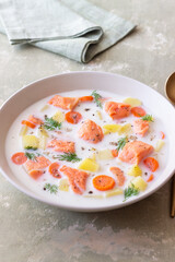 Finnish fish soup lohikeitto with salmon and vegetables. National cuisine. Healthy eating.