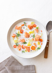Finnish fish soup lohikeitto with salmon and vegetables. National cuisine. Healthy eating.