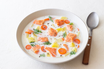 Finnish fish soup lohikeitto with salmon and vegetables. National cuisine. Healthy eating.