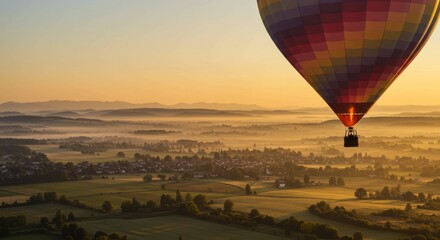 Fototapeta premium Colorful Hot Air Balloon Over Scenic Landscape at Sunrise