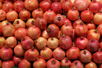 Pomegranates on display at a store that sells freshly squeezed pomegranate juice.