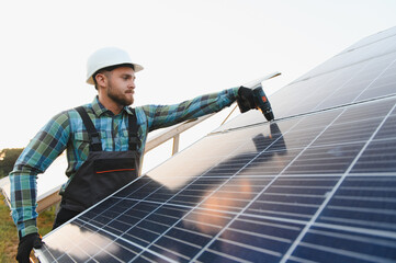 Technician installing solar panels for renewable energy production