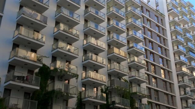 Glass balconies in multi-family buildings, apartment density, real estate, and housing market.