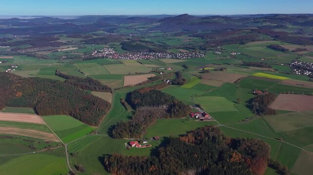 Aerial view of green fields and the village of Eichenzell, partially obscured by a blanket of low-lying clouds, Eichenzell, Hessen, Germany.