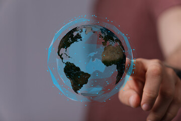 Modern technology, global network, futuristic concept. Hand interacts with digital earth.