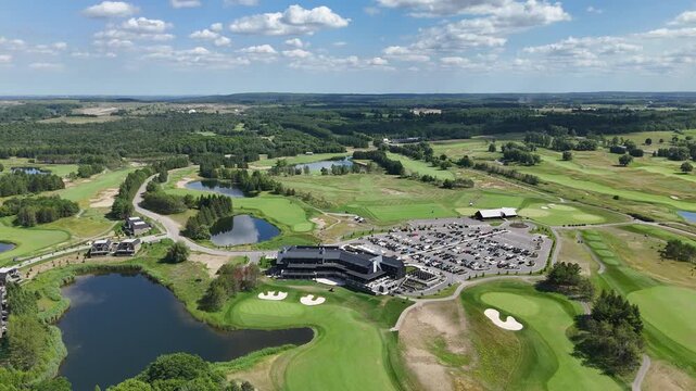 High drone shot showing TPC Toronto at Osprey Valley golf course with clubhouse, lakes and valley