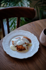 Plate with pancakes and condensed milk served on table. Dairy product