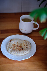 flatbread with cheese and cherry tomatoes. wooden background