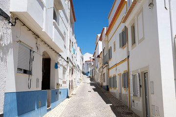Rua dos Pescadores a narrow street in Salema in the algarve, Portugal
