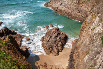 Looking down on Plemont beach after it is cut off by high tide
