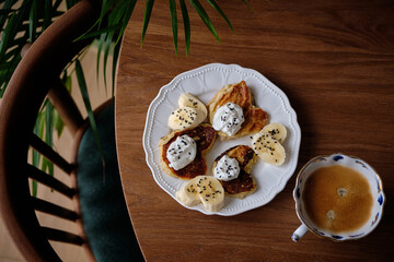 Heart-Shaped Pancakes. Pancakes with banana, sour cream, and black sesame seeds.
