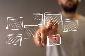 Hand interacts with digital files, folders, data management, cloud storage, organization concept.