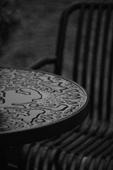 Black and white photo of raindrops on a table 