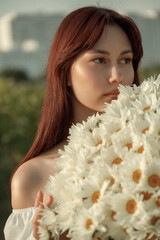 a bouquet of white daisies in close-up in the hands of a girl. film and grain effect