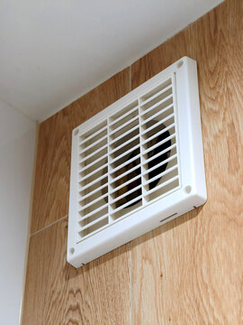 Close up of Bathroom ventilation fan in modern interior design apartment. Air circulation, suggesting ventilation, airflow in a residential space