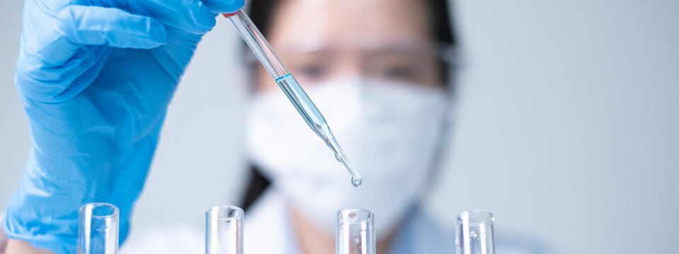 Young Asian woman scientist working science experiment laboratory research chemistry technology innovation data analysis biochemistry concept