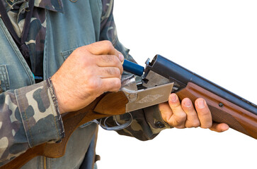 Hunter man in camouflage with a gun during the hunt in search of wild birds or game. Autumn hunting season.