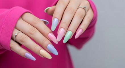 Female hands with long almond shaped nails featuring a pastel gradient design adorned with sparkling rings manicure beauty cosmetic stylish feminine fashion glamour accessories art