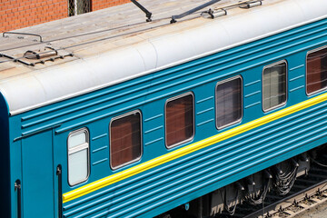 The image shows wagons in different colors, heading out on their way