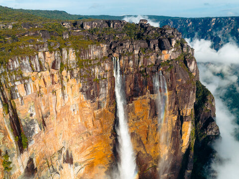 Aerial view of Angel Falls cascading down the steep, orange-streaked cliffs, contrasting with the surrounding lush greenery, Canaima National Park, Bol&Atilde;&shy;var, Venezuela.