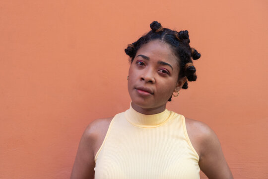 Black woman confidently posing with bantu knots hairstyle