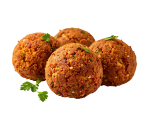Three golden-brown falafel balls, slightly overlapping, sit atop a bed of fresh herbs