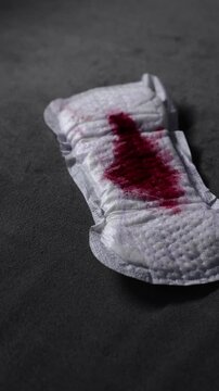 A sanitary pad to protect clothes from blood during menstruation.
Close-up of blood on a pad.
Women's health and regular menstrual cycles.
Gynecology, health, menstruation