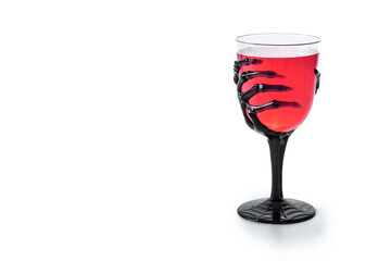 Halloween spooky red cocktail in skeleton hand glass isolated on white background. Copy space