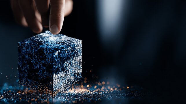 A human hand delicately interacts with a glowing, fragmented cube composed of countless digital particles, symbolizing data manipulation and the building blocks of virtual reality.