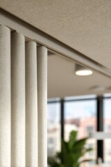 Modern office interior design with elegant textured curtains and natural light