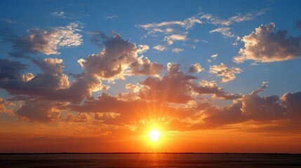 Fototapeta premium Vibrant Sunset Over a Serene Landscape with Colorful Clouds and Warm Sunlight Radiating Across the Horizon